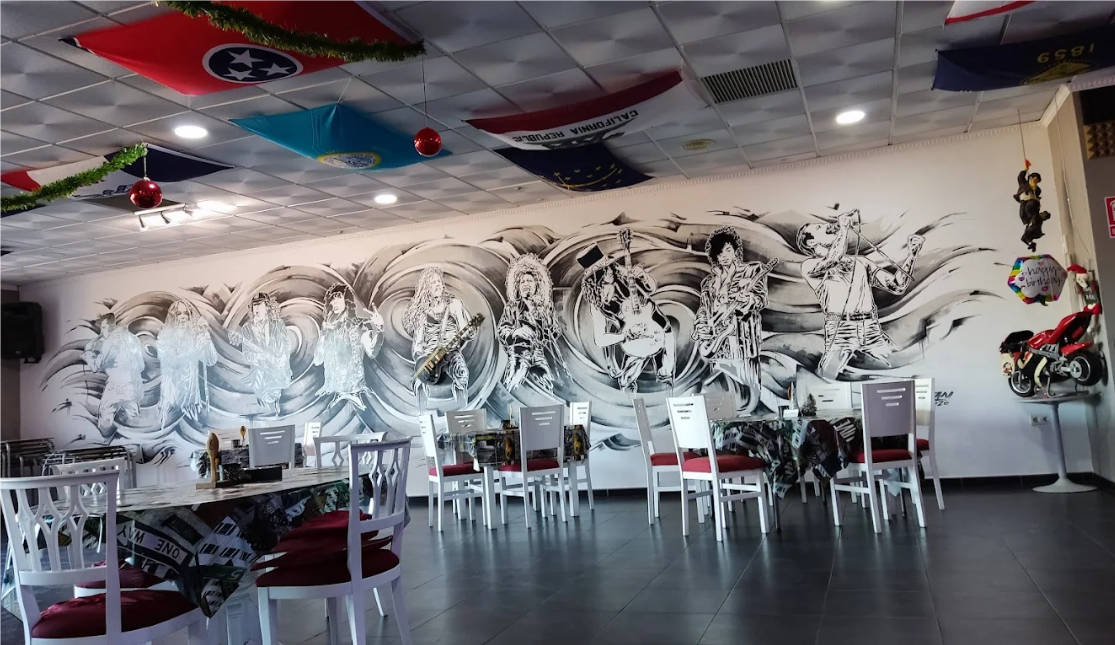 Inside Harley's Bar, Arboleas — mural of rock legends behind the dining area